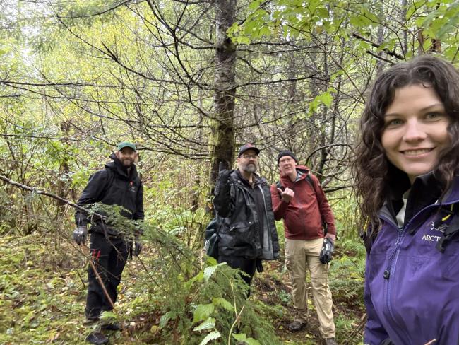 4 people standing in the forest