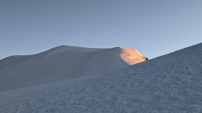 Sunrise hitting the true summit